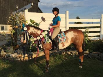 Woman on horse with prizes during Preston Rosedale Show